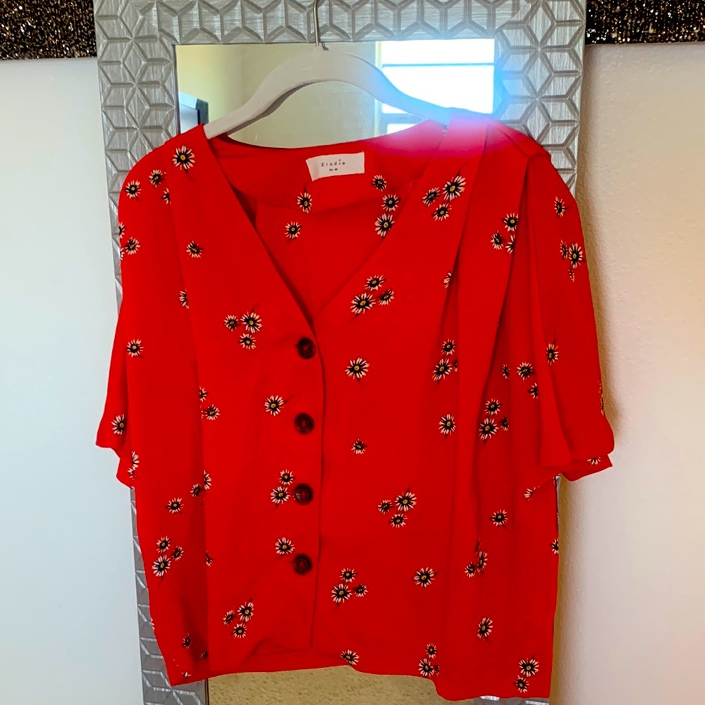 Red, short sleeve button up shirt.